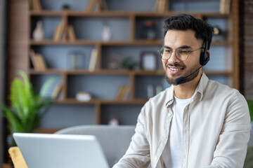 Smiling customer service representative working remotely with headset and laptop