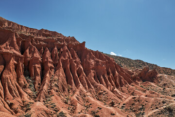 Fairytale canyon with red rocks. Picturesque Skazka Canyon on southern shore of Issyk-Kul lake,...