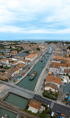 Obraz premium ITALY, 24 June 2024: aerial and panoramic view in 4k of Cesenatico with its beach, its sea and its canal with historic boats. We are on the Romagna coast in the province of Rimini