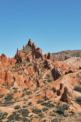 Picturesque Skazka Canyon on the southern shore of Issyk-Kul lake, Kyrgyzstan. Travel destination, landmark Kirgiziya. Summer fairytale canyon with colorful rocks and hills. Natural park landscape