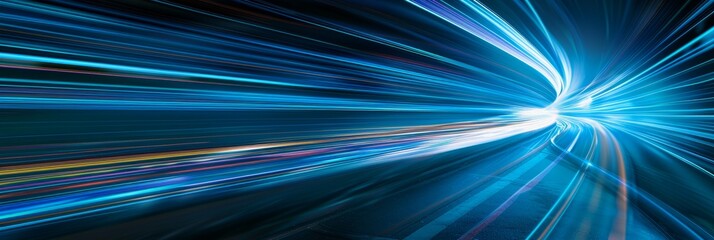 A high-angle photograph showcasing dynamic blue light streaks speeding across a dark background, evoking a futuristic sense of speed and motion