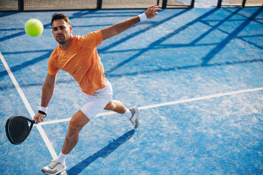 Sportsman practicing padel lob during training on the court