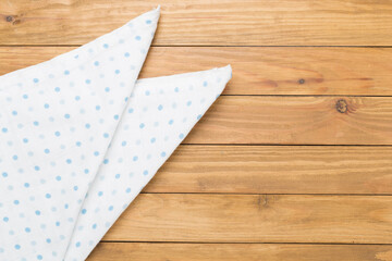 Cotton fabric on wooden background, top view