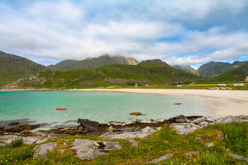 Panorama of Vik beach near Hauklandstranda beach with turquoise sea and mountains on a background on Vestvågøy island, Lofoten islands, Norway. Sea and mountains.