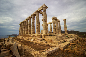 The ancient ruin of Poseidon, Cape of Sounion with cloudy weather near Athens, Greece.