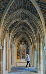 A student walks past the gothic arches at Duke Chapel on the campus of Duke University in Durham North Carolina