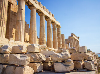 Fototapeta premium Ancient Parthenon Temple on top of the Acropolis Athens, Greece at sunny day with a blue sky. The landmark of Athens. Parthenon is the temple of for dedication to the goddess Athena.