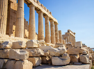 Ancient Parthenon Temple on top of the Acropolis Athens, Greece at sunny day with a blue sky. The landmark of Athens. Parthenon is the temple of for dedication to the goddess Athena.