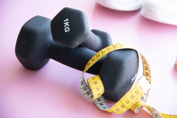 dumbbells and measuring tape