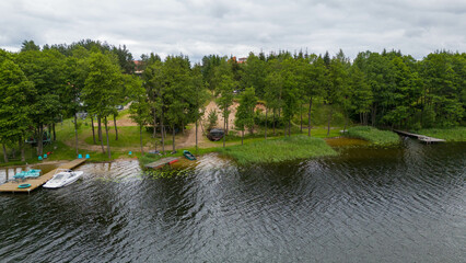 Drone photography of lake, forest and houses near it during summer day