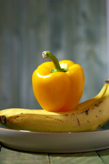 Dramatic food image with bananas and a bell pepper.