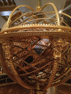 Florence ITALY - August 6, 2023 - Detail of Armillary sphere, object of astronomical calculations in gold with angel sculpture at Museum Galileo
