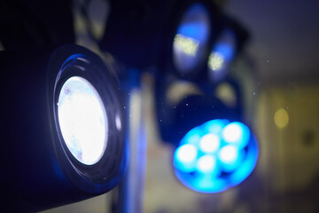 A detailed description of vibrant blue stage lights used for artistic performances