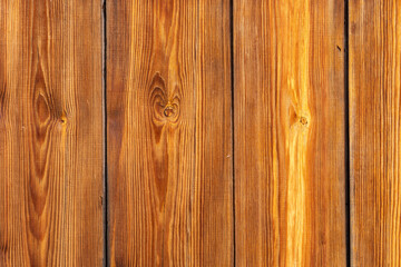Naklejka premium Background from untreated red wooden boards. Boards coated with anti-rot agent. Wood texture for your photos.