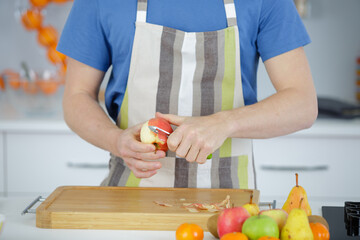 a man pealing apple with knife