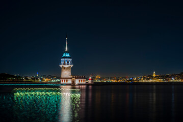 Fototapeta premium Colorful light trails from ships passing in front of the Maiden's Tower in Istanbul