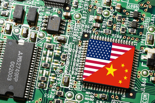 Flag of the Republic of China and the United States on microchip of a PC Motherboard. Concept for world supremacy in microchip and semiconductor manufacturing.