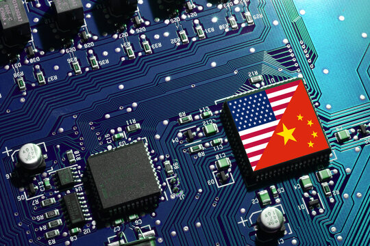 Flag of the Republic of China and the United States on microchip of a PC Motherboard. Concept for world supremacy in microchip and semiconductor manufacturing.