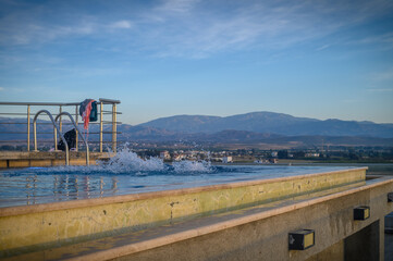 Obraz premium Beautiful little girl wearing swimsuit having fun outdoors on a hot sunny summer day 1