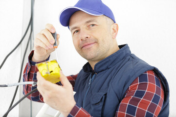 experienced electrician installing electric cables