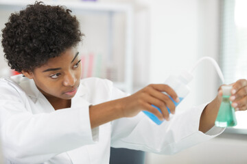 female scientist analyzes liquid conducting experiments