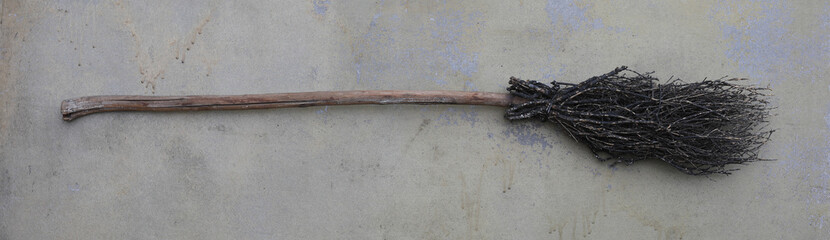 old broom on a dirty floor