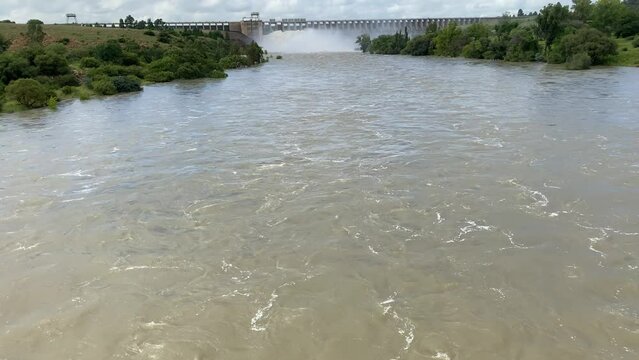Handheld tilt up shot of floodwaters of the Vaalriver beneath the dam wall af the Vaal dam in the Freestate Province of South Africa. 