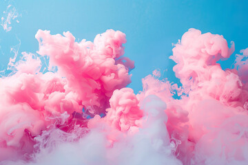 Fototapeta premium Pink and white smokey clouds with a blue sky background