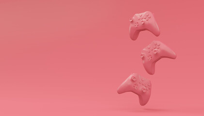 Video game joysticks or gamepads in plain monochrome pink color background