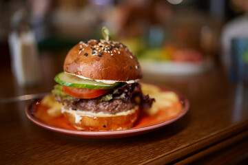 Delicious Gourmet Burgers beautifully presented on a Wooden Board at a Restaurant