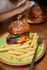 Delicious Gourmet Burgers beautifully presented on a Wooden Board at a Restaurant
