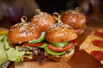 Delicious Gourmet Burgers beautifully presented on a Wooden Board at a Restaurant