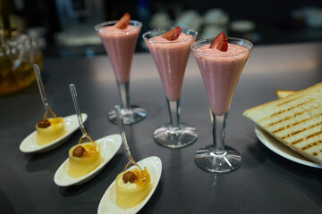 Assorted pastries such as jam tarts and layered desserts beautifully presented on slate trays