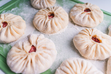 Fototapeta premium Close-up: open pies with meat or belyashi, ready for frying.