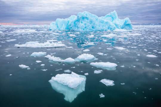 Giant floating blue iceberg in Ilulissat Icefjord in Greenland, World Heritage Site - Powered by Adobe