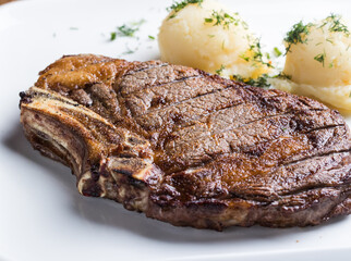 Grilled New York strip steak with bearnaise sauce, potato wedges