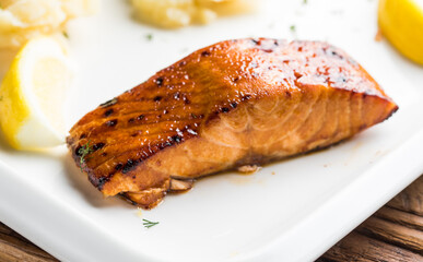 grilled salmon with vegetables on white plate