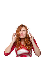 woman in her thirties with large headphones and a bewildered face 