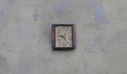 old vintage clock on a cement wall