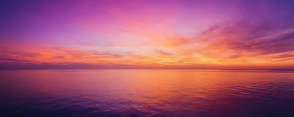 Vibrant sunset sky with fiery orange, pink, and purple hues. Perfect for backgrounds, travel brochures, or adding a dramatic touch to designs.