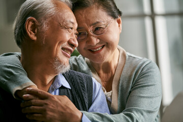 close-up portrait of loving senior asian couple happy and smiling