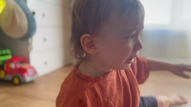 the portrait of little Toddler crying depressed. happy family kid dream concept. little baby is crying tears. blond boy in a colored T-shirt crying on camera, face close-up lifestyle