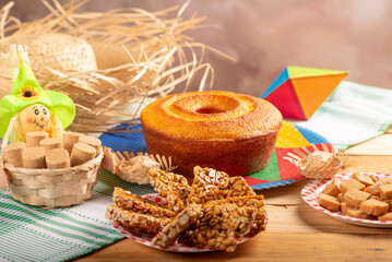 Festa Junina, beautiful rustic table with dishes containing various types of sweets for Festa Junina in Brazil, selective focus.