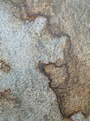 A wall with a brown stain that looks like a heart