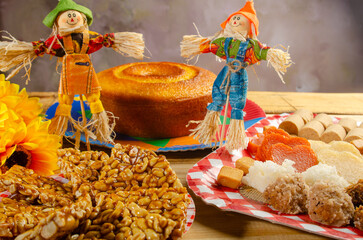 Festa Junina, beautiful rustic table with dishes containing various types of sweets for Festa Junina in Brazil, selective focus.