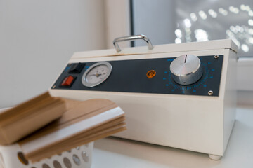 Closeup on mini autoclave machine for sterilization manicure instruments