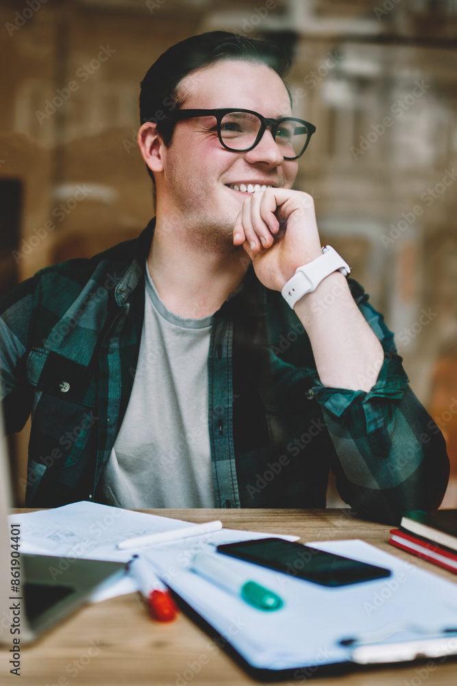 Poster prosperous male freelancer in good mood satisfied with completing project sitting with laptop comput
