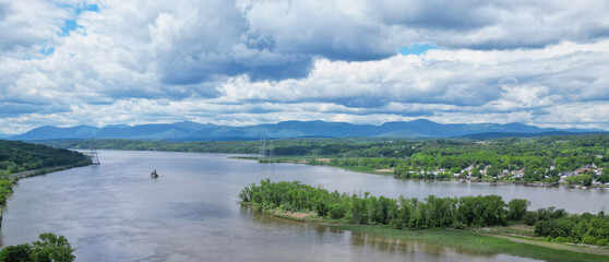 view of the hudson river and catskills mountains from a park in hudson new york valley (lighthouse, water clouds harbor coastline scene) aerial beautiful travel destination ny state public land