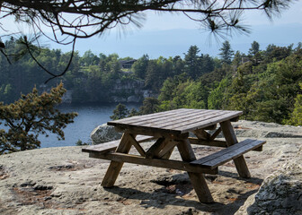 picnic table at the top of a mountain hike trail in minnewaska state park (hiking overview point in mountains with lake pond) beautiful nature landscape lunch meeting spot hudson valley shawangunk