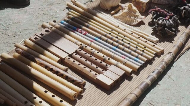 A collection of wooden instruments, including flutes and clarinets, are displayed on a table